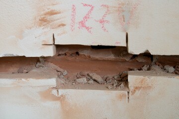 Home demolition. Hole in a wall showing the electricity conduit pass. Moving the eletrical points to new positions