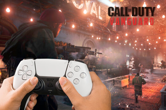 Female hand holding a Playstation 5 Dual Sense Controller with Call of Duty Vanguard game blurred in the background. Rio de Janeiro, RJ, Brazil. October 2021