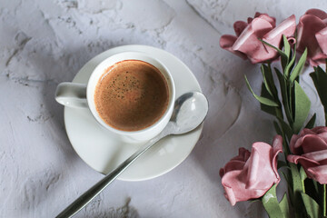 Coffee cup with rose flower on white table background. Valentine day with place for text. Vintage photo. Space for text