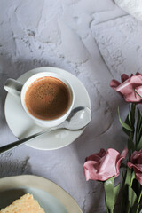 Coffee cup with rose flower on white table background. Valentine day with place for text. Vintage photo. Space for text