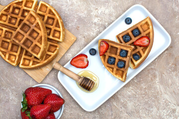 Waffles with blueberries, strawberries and honey