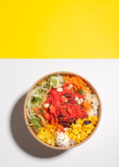 a salad poke with yellow bottom, asian hawaiian food, chopsticks, carrot, beans, pineapple, soy, jicama, seaweed, healthy food