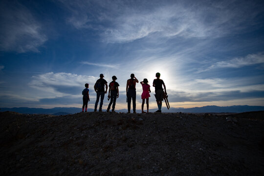 silhouettes of people hiking