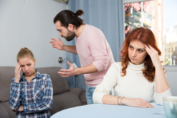 Fototapeta premium Portrait of sad mature woman sitting after conflict with adult children in home interior