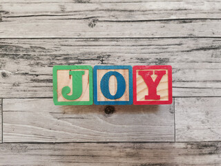 Joy. Joy word from wooden letter blocks. Suitable for educational media for children