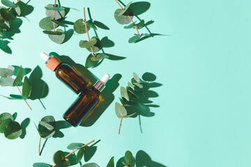 Bottles of healthy eucalyptus essential oil on color background © Pixel-Shot