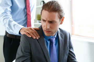 Boss seducing male worker in office. Concept of harassment