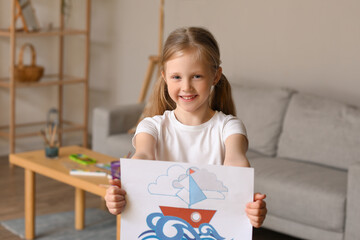 Little girl with drawing of ship at home