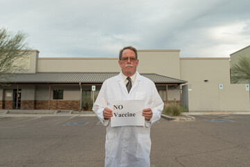 Physician activist holds sign in protest against covid vaccine mandate