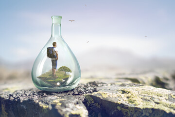 Young traveler inside glass bottle