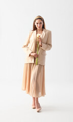 Beautiful young woman with calla flower on light background