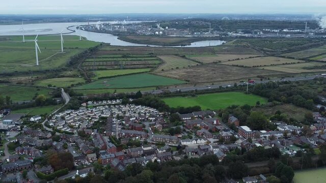 Aerial view above Halton North England Runcorn Cheshire countryside wind turbines industry landscape reverse orbit right