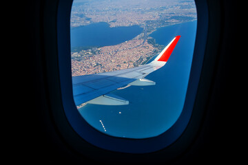 Fototapeta na wymiar Looking through window aircraft during flight in wing lands over Istanbul in sunny weather