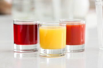 Fototapeta na wymiar Glasses with healthy juice on table in room