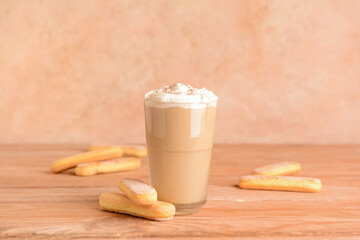 Glass of tasty Tiramisu Latte on table
