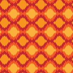 Fototapeta premium Abstract geometric seamless pattern. Red and orange tiles, tongues of flame ornament. Bright decorative retro background