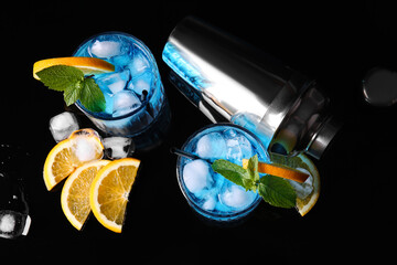 Glasses of Blue Lagoon cocktail on dark background