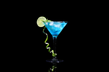 Glass of Blue Lagoon cocktail on dark background