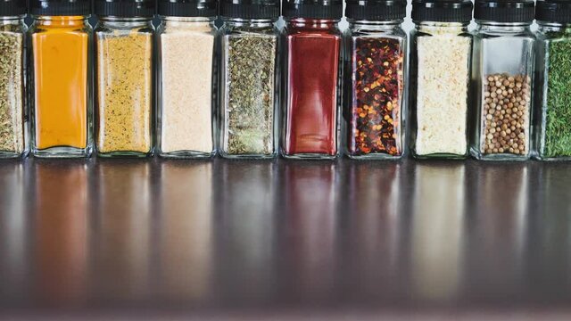 spices seeds and seasonings in mathing spice jars on kitchen benchtop, simple vegan ingredients and flavoring your dishes
