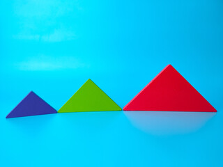 Colored tangrams arranged on a blue background.