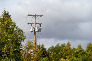 Fall landscape with moody sky and a wooden utility pole with transformers, King Salmon, Alaska
