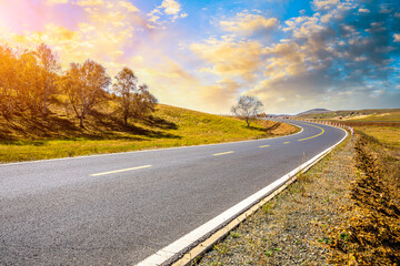 Asphalt road and mountain nature landscape at sunset.Road and mountain scenery in autumn.