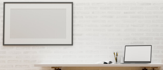 Laptop blank screen and copy space on table, poster frame mockup on white brick wall