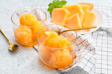 Bowls with delicious melon sorbet on light background - obrazy, fototapety, plakaty