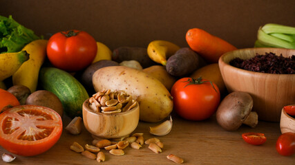 vegetables, seeds, nuts, rice berry, fruits on wooden table. vegan, plant-based, organic.