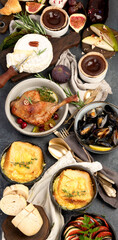 French food assortment on dark background.