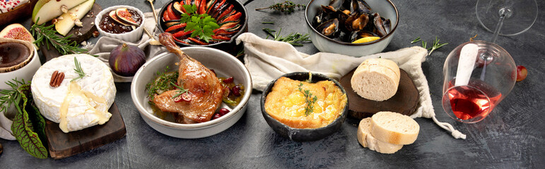French food assortment on dark background.
