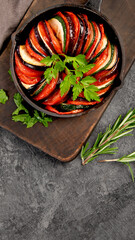 Ratatouille casserole on dark background.