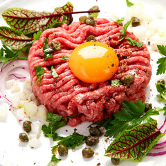 Beef steak tartare on light background. French cuisine concept.