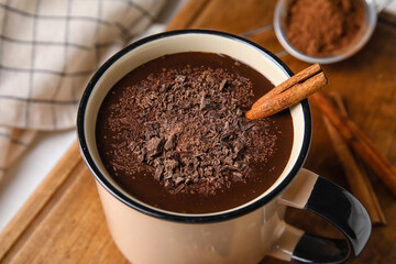 Mug of delicious hot chocolate on table, closeup