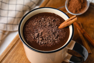Mug of delicious hot chocolate on table, closeup