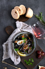 Mussels with snacks on dark background.