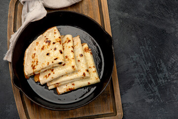 Crepes with sweet toppings on dark background.
