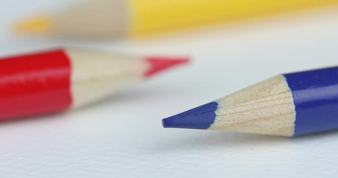 Three Colored Pencils On White Background, Focused On Blue Pencil - macro