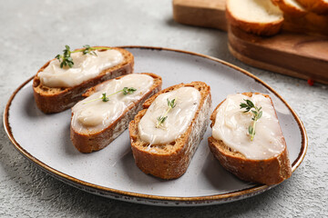 Plate of bread with lard spread on light background