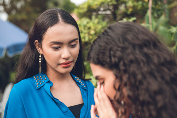 A Filipina woman listens to her sobbing friend emotionally opening up about relationship troubles...