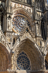 Close up view of the ornate medieval Our Lady of Reims Cathedral (Notre-Dame de Reims) in France, with high Gothic architecture, showing its central rose window
