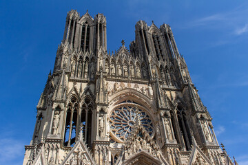 Fototapeta premium Close up view of the ornate medieval Our Lady of Reims Cathedral (Notre-Dame de Reims) in France, with high Gothic architecture, showing its central rose window