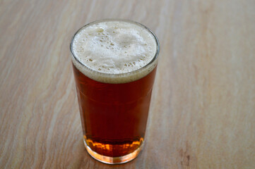 A glass of amber ale on the table