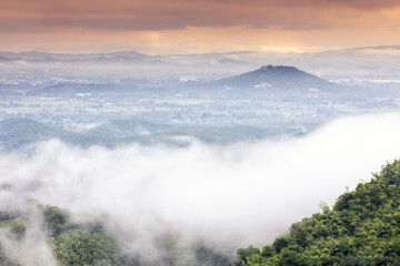 Fototapeta premium Aerial view of Sun rise with fog Over City and mountain range at Chiangrai Thailand, date photo taken 20 October 2021