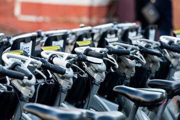 Street parking with bicycles  for rent in the bright sun