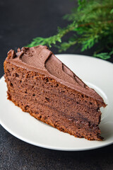 piece of chocolate cake cocoa sponge cake, chocolate ganache, brown cream sweet dessert ready to eat meal snack on the table copy space food background rustic. top view