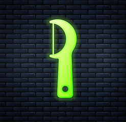 Glowing neon Dental floss icon isolated on brick wall background. Vector