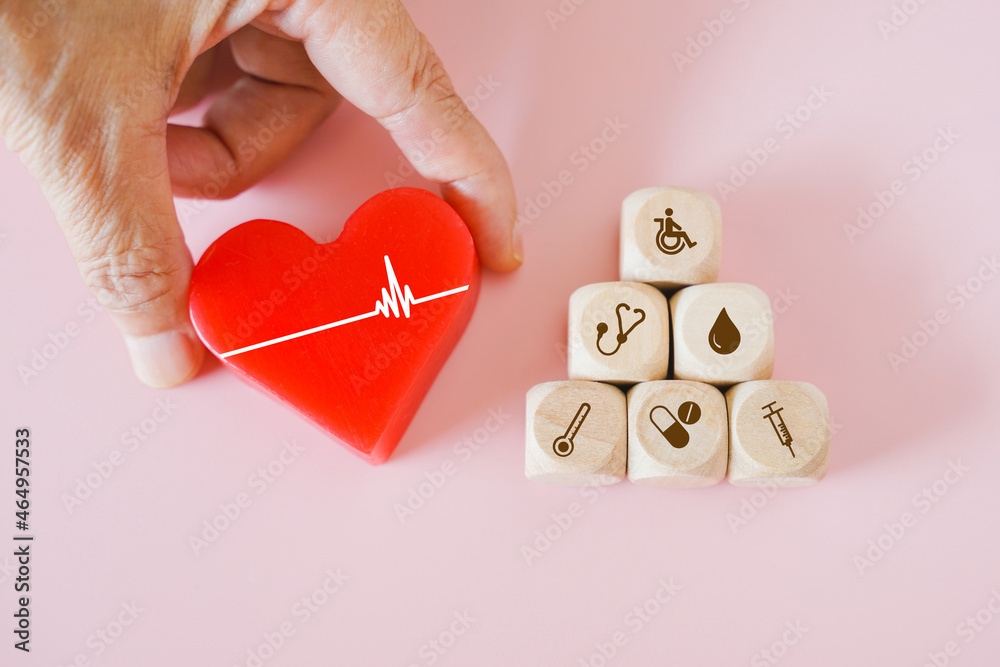 Canvas Prints senior's hand holding red heart with heartbeat and pyramid of health and medical icon on wood cubes on pink background, health and medical insurance, wellness, wellbeing concept