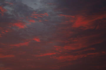 dramatic clouds in crimson color during sunrise