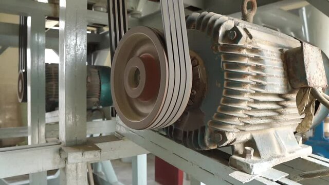 Spinning Belt Drive Electric Motor Generators At Flour Mill Factory In Pakistan. Dolly Right Reveal
